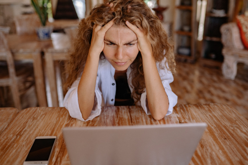 Frustrated woman in front of her computer